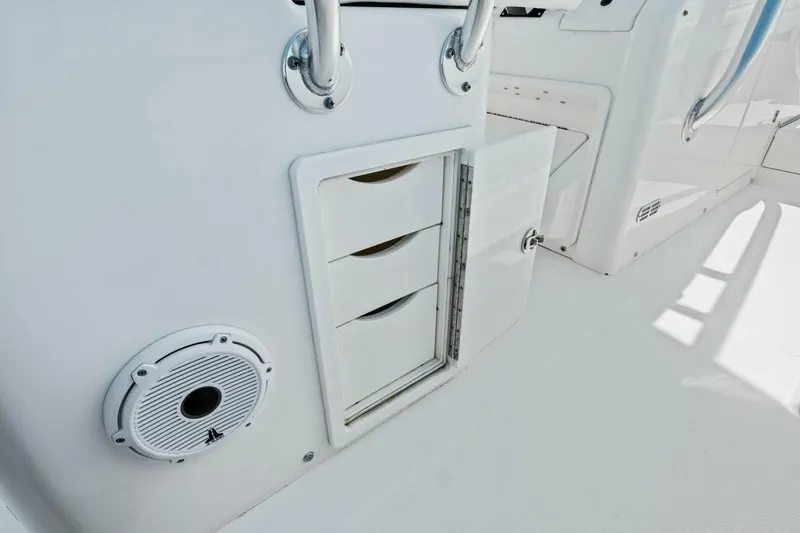 Slide: The Image of 2012 Regulator 32 FS boat interior with storage compartments and speaker. - 16