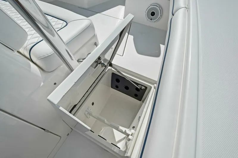 Slide: The Image of Open storage compartment on 2012 Regulator 32 FS boat, featuring white interior and seating. - 18