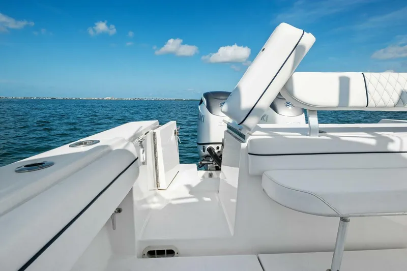Slide: The Image of 2012 Regulator 32 FS boat interior with white seating, ocean view, and clear blue sky. - 19