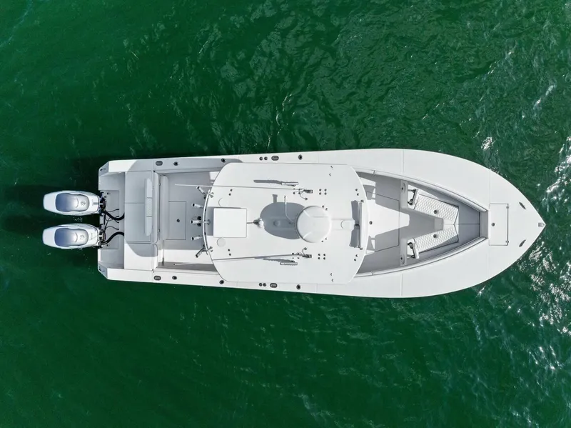 Slide: The Image of Overhead view of a 2012 Regulator 32 FS boat on green water. - 22