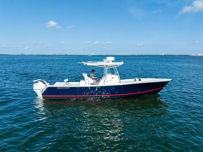 Slide: The Image of 2012 Regulator 32 FS boat on calm blue water under clear sky. - 23
