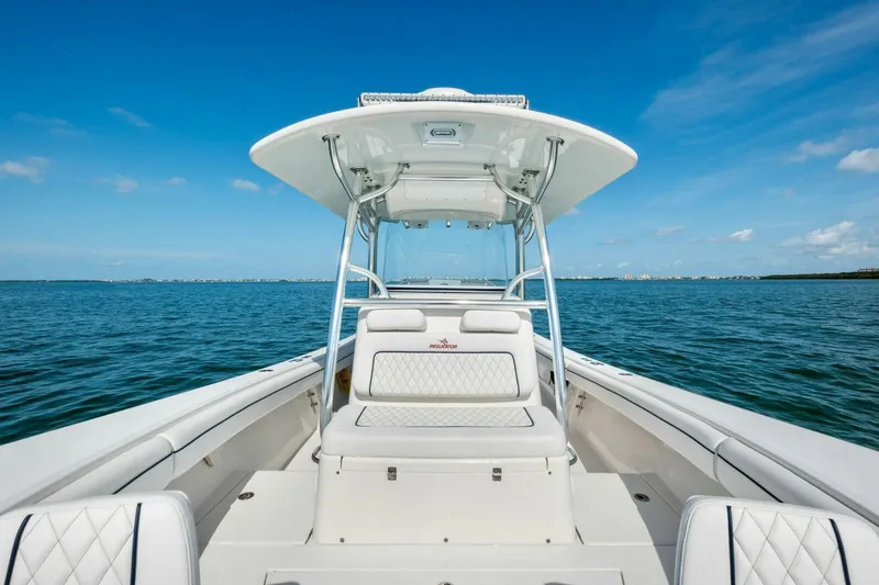 Slide: The Image of 2012 Regulator 32 FS boat on open water under clear blue sky. - 3