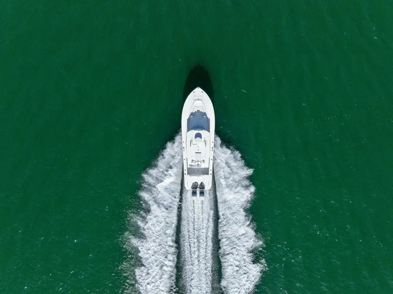 Slide: The Image of Aerial view of 2012 Regulator 32 FS boat cruising on green water. - 30