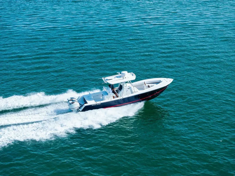 Slide: The Image of 2012 Regulator 32 FS boat cruising on open water, creating a wake. - 31