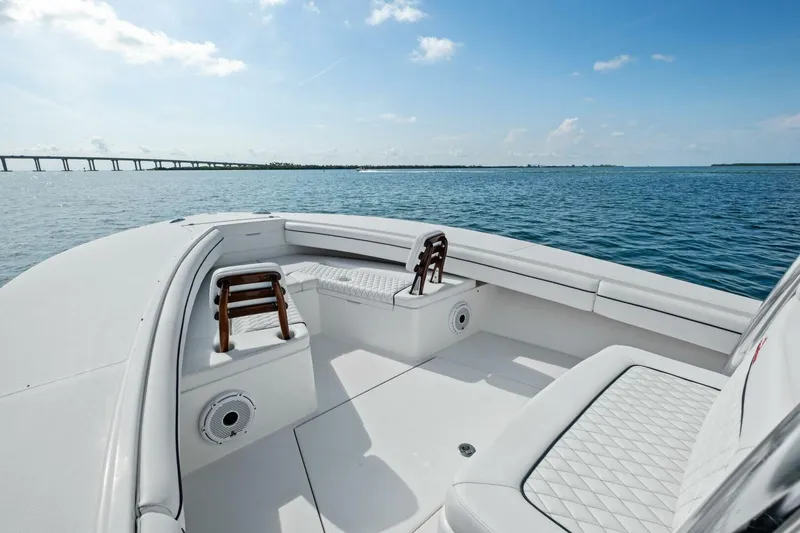 Slide: The Image of 2012 Regulator 32 FS boat interior with seating, on calm water under blue sky. - 8