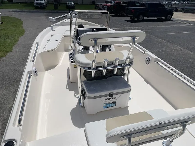 Slide: The Image of 2025 Bulls Bay 2200 boat interior with seating and cooler on a sunny day. - 11