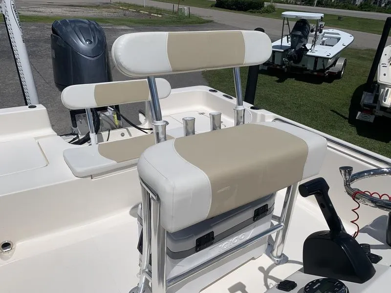 Slide: The Image of 2025 Bulls Bay 2200 boat interior with beige and white seating, featuring a modern console. - 13
