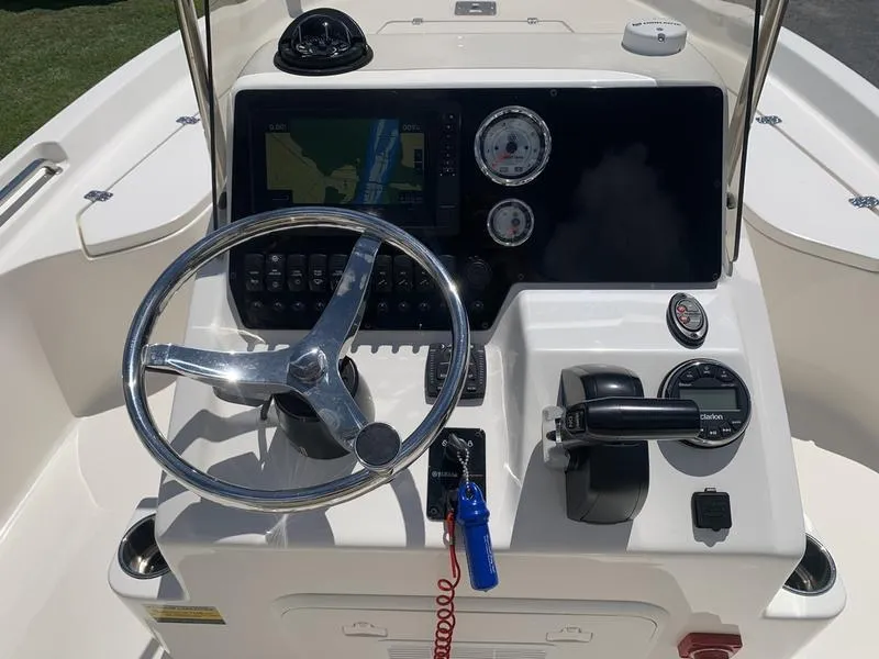 Slide: The Image of 2025 Bulls Bay 2200 boat console with steering wheel, gauges, and navigation system. - 15