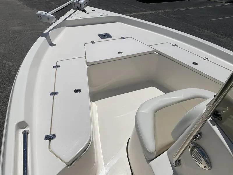 Slide: The Image of 2025 Bulls Bay 2200 boat interior with white seating and storage compartments. - 19