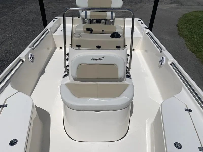 Slide: The Image of 2025 Bulls Bay 2200 boat interior with seating and console, featuring a sleek white design. - 22