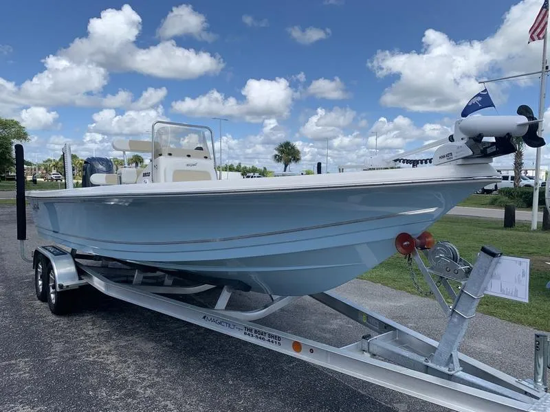 Slide: The Image of 2025 Bulls Bay 2200 boat on trailer under a blue sky with clouds. - 6