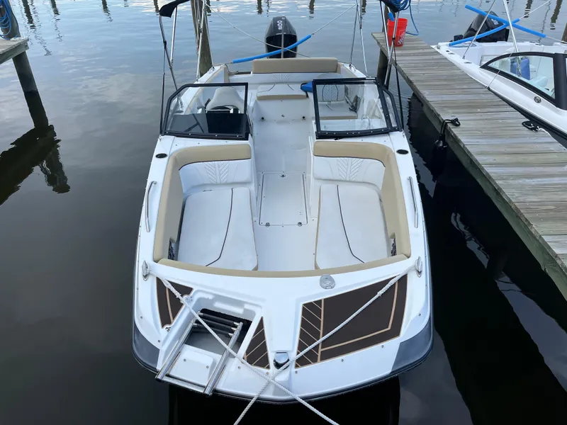 Slide: The Image of 2022 Glastron GTD 220 boat docked at marina, top view. - 2