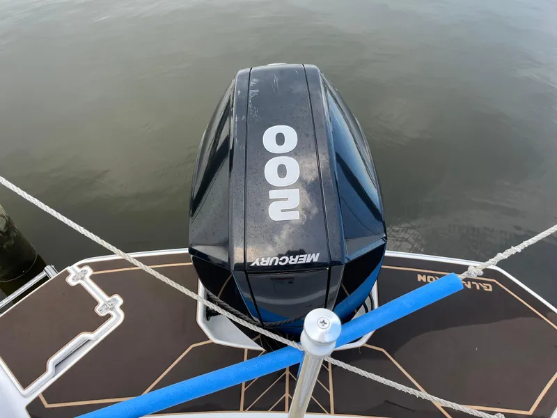 Slide: The Image of 2022 Glastron GTD 220 boat with Mercury 200 outboard motor on calm water. - 8