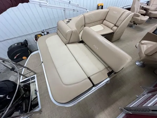 Slide: The Image of 2016 Harris Solstice 220 SL boat interior with beige seating and adjustable lounge. - 10