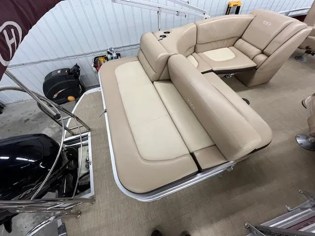 Slide: The Image of 2016 Harris Solstice 220 SL boat interior with beige seating and cup holders. - 11