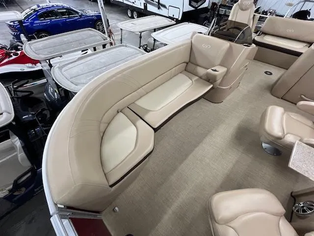 Slide: The Image of 2016 Harris Solstice 220 SL boat interior with beige seating and carpet flooring. - 13