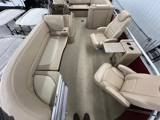 Slide: The Image of 2016 Harris Solstice 220 SL boat interior with beige seating and table. - 14