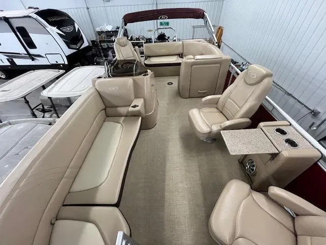 Slide: The Image of 2016 Harris Solstice 220 SL pontoon boat interior with beige seating and table. - 16