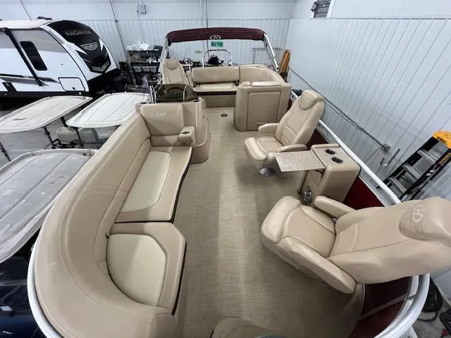Slide: The Image of 2016 Harris Solstice 220 SL pontoon boat with beige seating in a storage facility. - 17