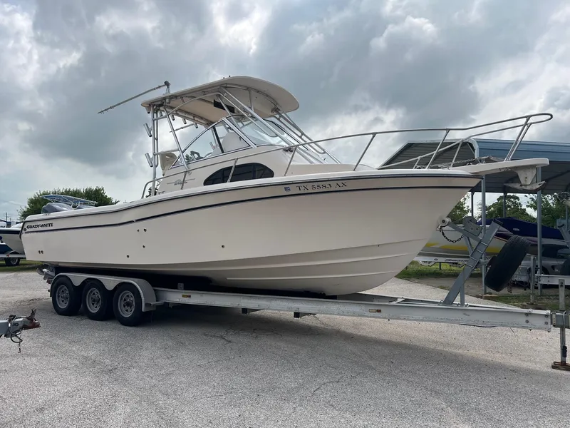 Slide: The Image of 2008 Grady-White 282 Sailfish WA boat on a trailer under cloudy skies. - 1