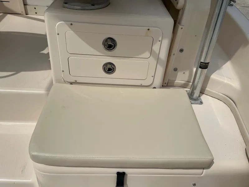 Slide: The Image of 2008 Grady-White 282 Sailfish WA boat interior with storage drawers and cushioned seat. - 11