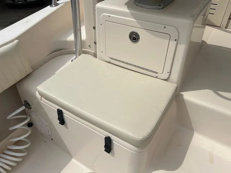 Slide: The Image of 2008 Grady-White 282 Sailfish WA boat interior with cushioned seating and storage compartment. - 12