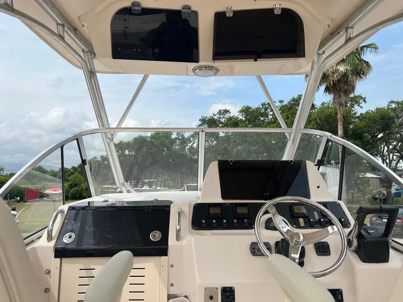 Slide: The Image of 2008 Grady-White 282 Sailfish WA helm with steering wheel and control panel. - 17