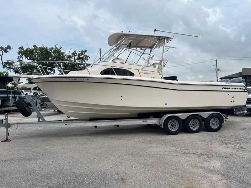 Slide: The Image of 2008 Grady-White 282 Sailfish WA boat on trailer, parked outdoors. - 2