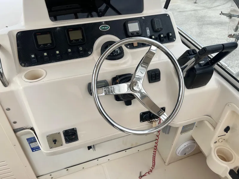 Slide: The Image of 2008 Grady-White 282 Sailfish WA helm with steering wheel and control panel. - 21