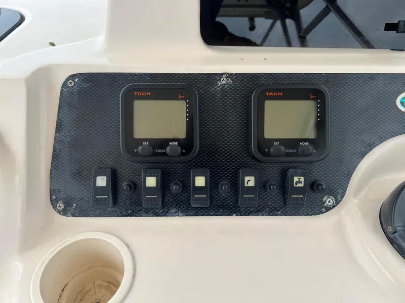 Slide: The Image of Control panel of 2008 Grady-White 282 Sailfish WA boat with tachometers and switches. - 23