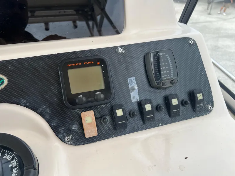 Slide: The Image of Control panel of 2008 Grady-White 282 Sailfish WA boat with speed and fuel gauges. - 24