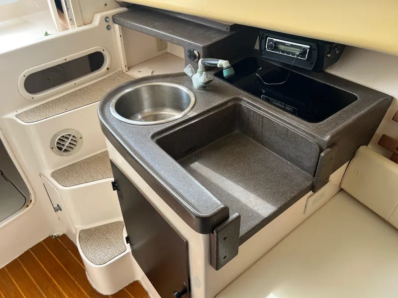 Slide: The Image of 2008 Grady-White 282 Sailfish WA boat interior with sink and stereo system. - 27