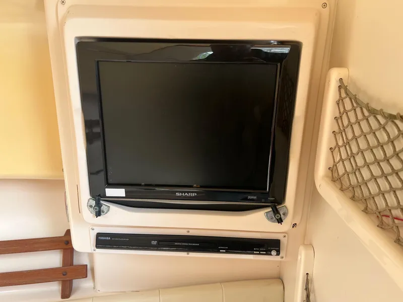Slide: The Image of Sharp TV and Toshiba DVD player inside 2008 Grady-White 282 Sailfish WA boat cabin. - 32