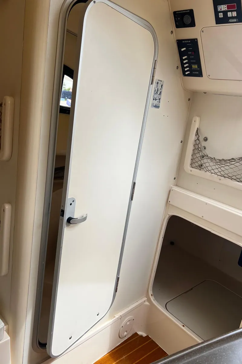 Slide: The Image of Interior cabin of 2008 Grady-White 282 Sailfish WA boat, featuring door and control panel. - 38