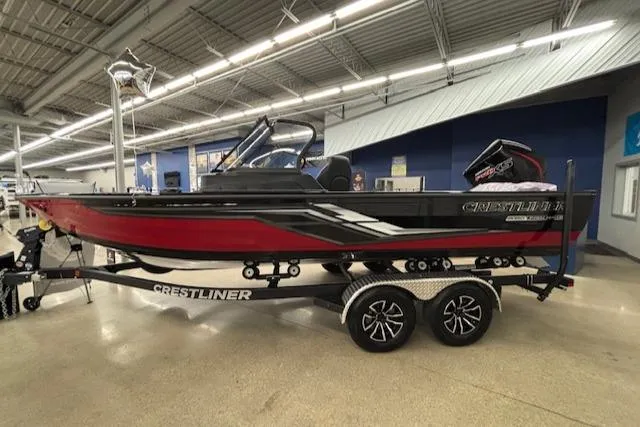 The Image of 2025 Crestliner 2050 Fish Hawk boat in showroom, red and black design, on a trailer. - 0