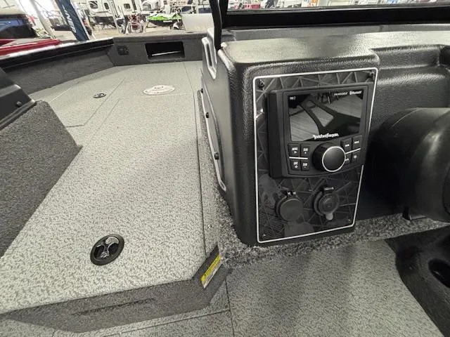 Slide: The Image of 2025 Crestliner 2050 Fish Hawk boat interior with control panel and textured flooring. - 20