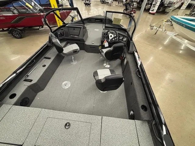 Slide: The Image of 2025 Crestliner 2050 Fish Hawk boat interior with seating and control console. - 25