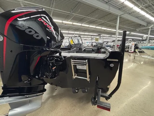 Slide: The Image of 2025 Crestliner 2050 Fish Hawk boat with powerful 300 HP engine in showroom. - 3