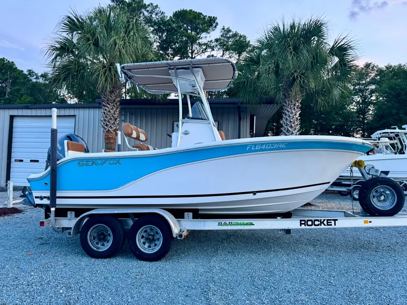 Slide: The Image of 2017 Sea Fox 186 Commander boat on trailer, parked near palm trees. - 0