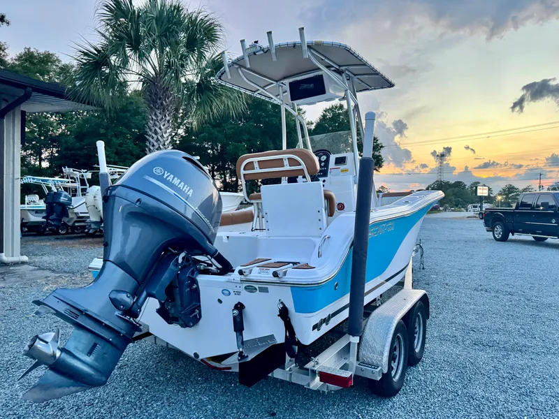 Slide: The Image of 2017 Sea Fox 186 Commander boat with Yamaha engine at sunset in a parking lot. - 1
