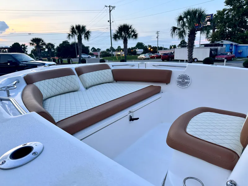Slide: The Image of 2017 Sea Fox 186 Commander boat interior with cushioned seating and palm trees in the background. - 8