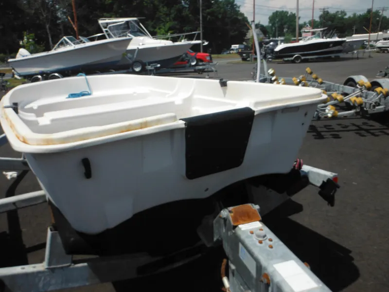 Slide: The Image of 2006 Sun Dolphin WATERTENDER 9.4 boat on trailer in a marina. - 4