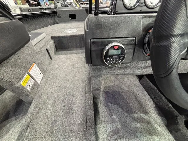 Slide: The Image of 2025 Crestliner 1850 Super Hawk WT JS interior with steering wheel and control panel. - 16