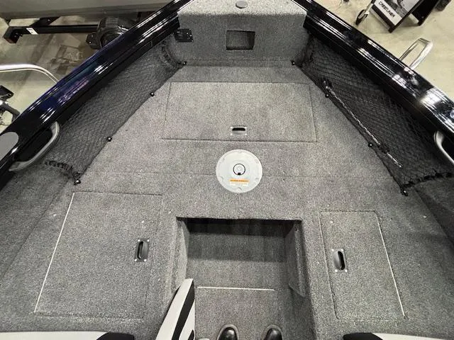 Slide: The Image of 2025 Crestliner 1850 Super Hawk WT JS boat interior with carpeted deck and storage compartments. - 7