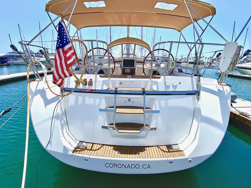 Slide: The Image of Jeanneau 57 sailboat, 2014 model, docked in Coronado, CA, with American flag. - 11
