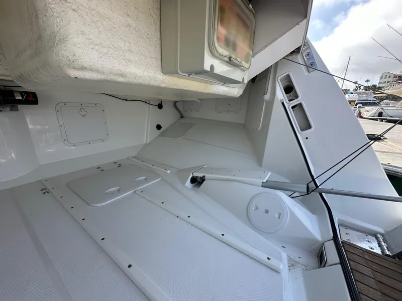 Slide: The Image of 2014 Jeanneau 57 yacht deck, featuring sleek design and spacious layout at the marina. - 16