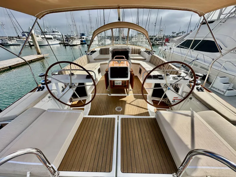 Slide: The Image of 2014 Jeanneau 57 yacht interior with dual steering wheels and spacious deck. - 18