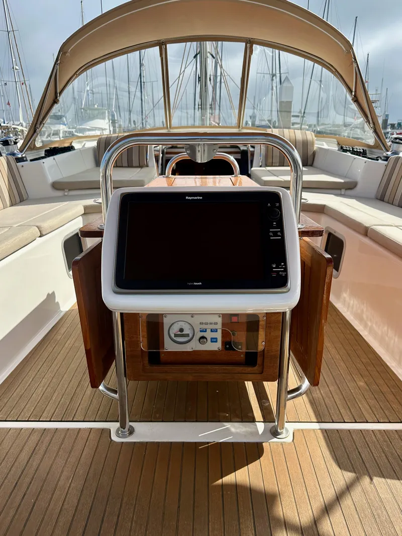 Slide: The Image of 2014 Jeanneau 57 yacht cockpit with navigation system and teak decking. - 22