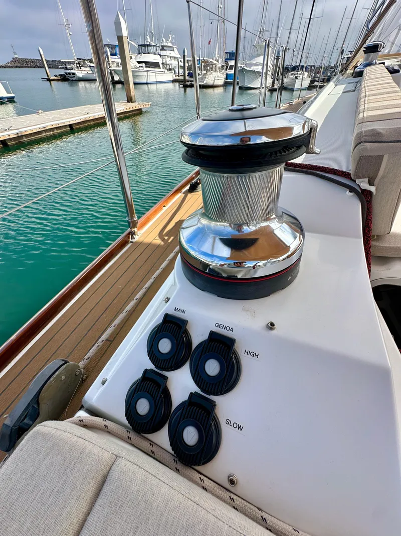 Slide: The Image of Jeanneau 57 sailboat deck with winch and control buttons, docked at marina, 2014 model. - 27