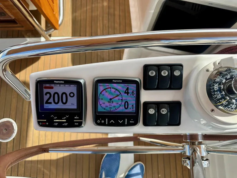 Slide: The Image of Control panel of a 2014 Jeanneau 57 yacht with navigation instruments and compass. - 32